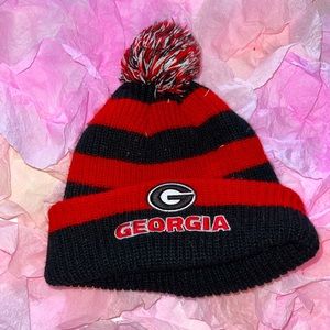 UGA knit hat with UGA logo and puffball at top. Very warm.